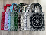 Set of bandana bags with various patterns and colors arranged on a wooden surface.