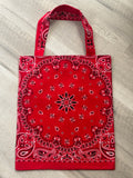 Red bandana-patterned bag on a wooden surface