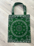 Green bandana patterned bag on a light wooden surface