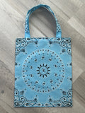 Blue bandana patterned bag on a wooden floor